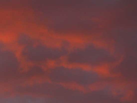 Faces in the hell-red clouds of sunset along the East Carson River.